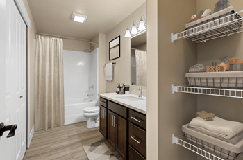 A bathroom with a toilet, sink, and shower.